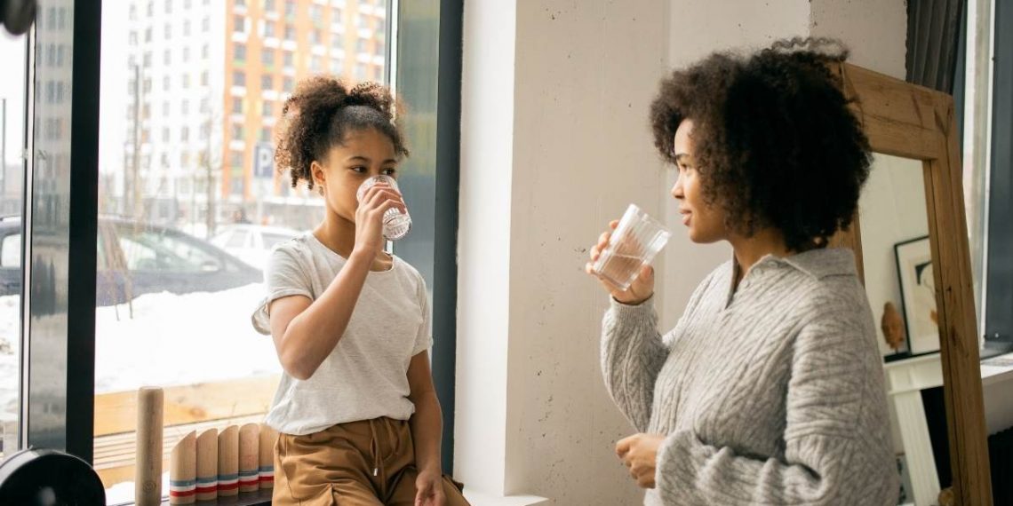 a woman and teenage girl having a serious conversation about addiction