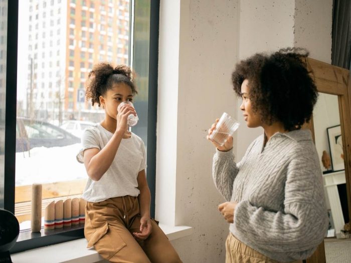a woman and teenage girl having a serious conversation about addiction